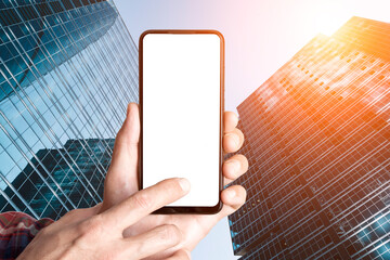 Smartphone Mockup in Hands Against Modern City Skyscrapers