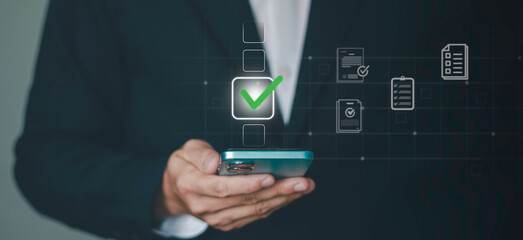 checkmark for digital approval and task completion. online procurement documents, contract warranties and licenses on mobile procurement devices for businesses and startups © Krittamet