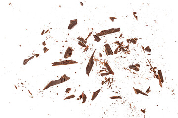 Top view of scattered dark chocolate fragments and crumbs isolated on white background, abstract...