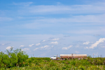 truck with tanks driving parking abandoned at a small road in the landscape