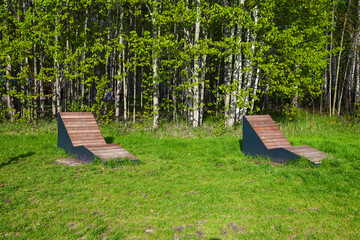 two benches in a clearing in the forest