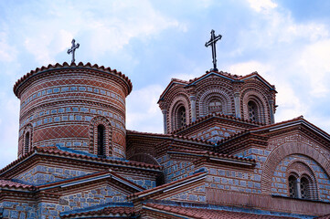 Architectural detail of the Saint Panteleimon church domes in Ohrid, featuring traditional Byzantine brickwork and stone under a dramatic sky.