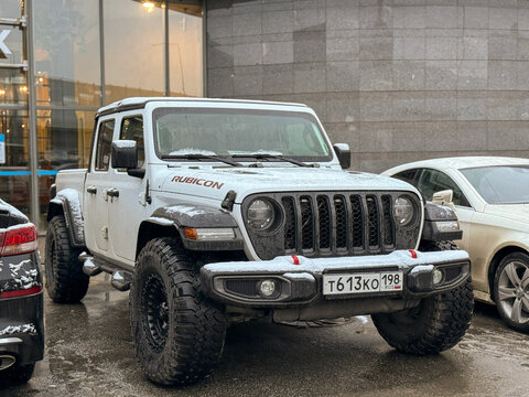 White Jeep Gladiator Rubicon truck 4x4 off road parked on street. Exterior Jeep Rubicon Wrangler Gladiator American off-road us vehicle. American off-road Truck. 