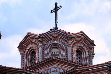 Architectural detail of the Saint Panteleimon church domes in Ohrid, featuring traditional Byzantine brickwork and stone under a dramatic sky.