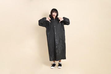 20s Asian woman wearing raincoat