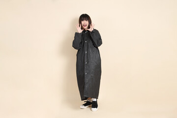 20s Asian woman wearing raincoat