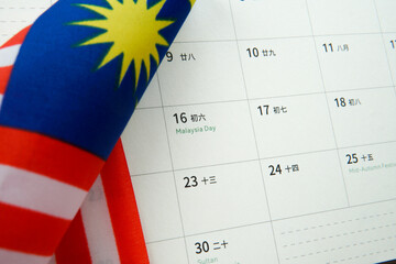 Close up calendar showing Malaysia Day with Malaysian flag. Concept of national pride, patriotism,...