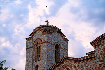 Architectural detail of the Saint Panteleimon church domes in Ohrid, featuring traditional Byzantine brickwork and stone under a dramatic sky.