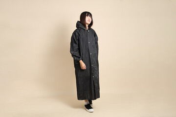 20s Asian woman wearing raincoat