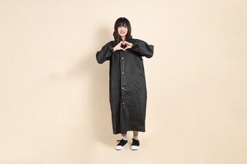 20s Asian woman wearing raincoat