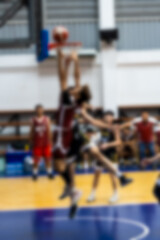Blurred of basketball player making slam dunk