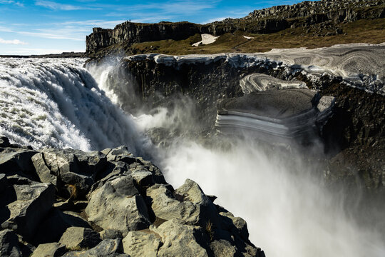 View of the powerful Dettifoss waterfall cascading over rugged cliffs, sending mist into the air in Vatnajokull Park, Northeast Iceland, Iceland.