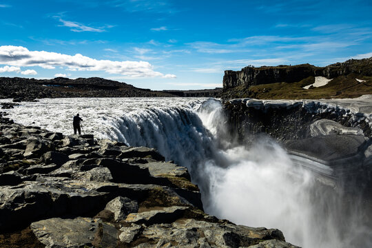 View of the Dettifoss waterfall plunges into a misty abyss, its thunderous roar echoing through the stark, rocky landscape, Vatnajokull Park, Northeast Iceland, Iceland.