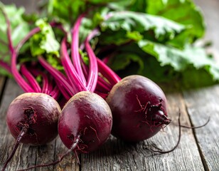 Three vibrant beetroots, bulbs on a rustic wooden surface, with leafy greens arranged. The roots are deep purple, with a natural light