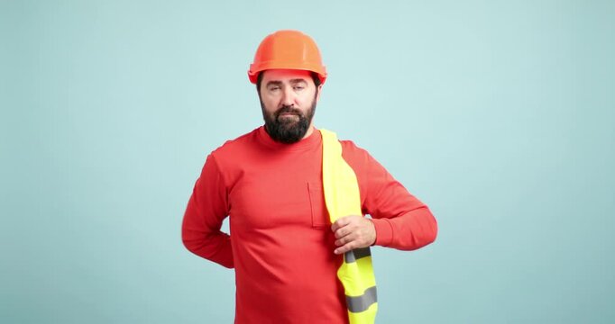 Construction worker putting on safety gear and hard hat