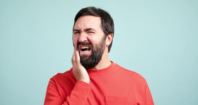 Bearded man suffering from a strong toothache