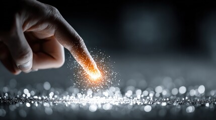 A finger touches a glowing point on a dark surface