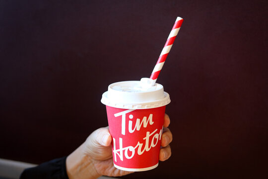 Toronto, Canada - September 14, 2025: Hand holding a hot beverage from Tim Hortons.