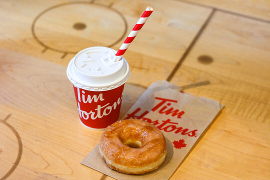 Toronto, Canada - September 14, 2025: A Maple Butter Glaze Donut and a hot beverage from Tim Hortons.
