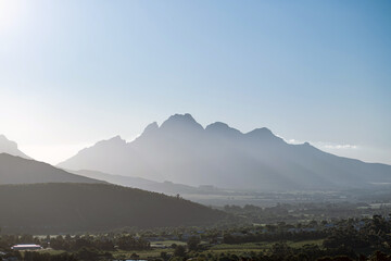 Mountain peaks in soft morning light over a valley. Peaceful nature landscape for travel and adventure concept. Outdoor scenery. South Africa