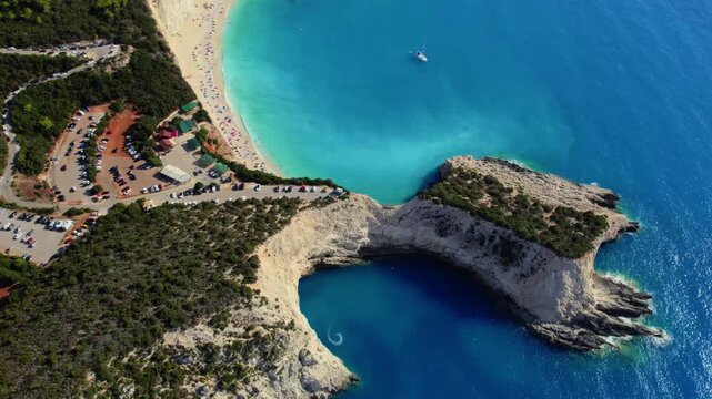 Aerial view of Porto Katsiki beach, where turquoise waters meet the stark white cliffs, contrasting with the lush greenery, Lefkada Island, Lefkada, Greece.