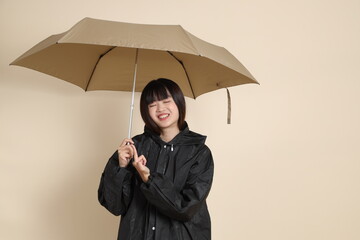 20s Asian woman wearing raincoat