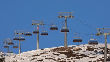 Ski resort chairlift ascending snowy mountain