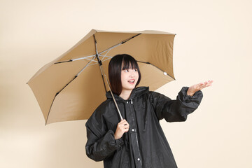 20s Asian woman wearing raincoat
