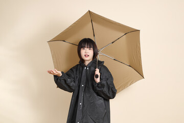 20s Asian woman wearing raincoat