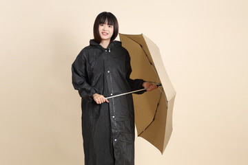 20s Asian woman wearing raincoat