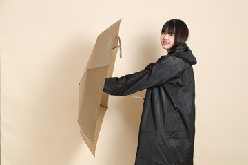 20s Asian woman wearing raincoat