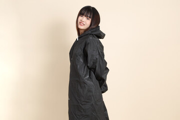 20s Asian woman wearing raincoat