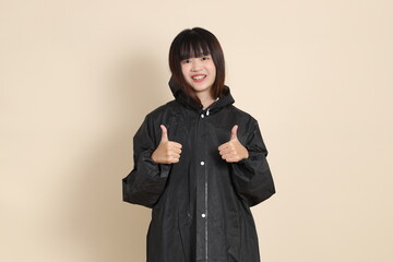 20s Asian woman wearing raincoat