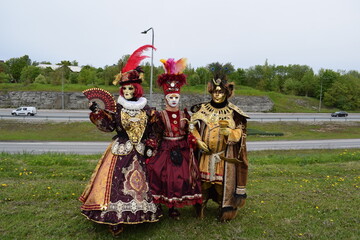 Group of People in Traditional Venetian Carnival Masks and Elegant Baroque Costumes
