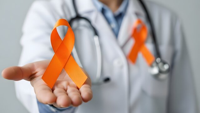 Doctor holding an orange ribbon representing leukemia awareness and support for cancer patients