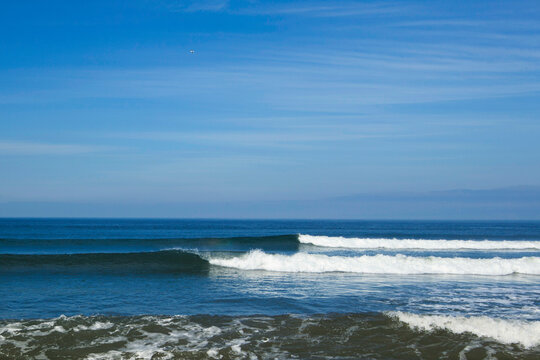 Ocean Waves rolling towards the shore, white water and spray on the breakers.