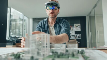 Medium shot of a designer using augmented reality to visualize architectural plans in a modern office setting for immersive project drafting. - Powered by Adobe