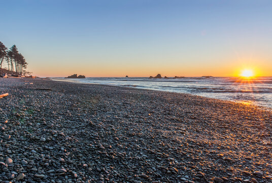 The view from Ruby Beach over the sea at sunset and sea stacks in the distance at Olympic national park