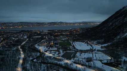 Fototapeten Polarkreis Drone photography of the city of Tromsdalen, in the foreground, and the island of Tromsø in the background, during a lovely spring evening in the arctic circle, Norway.  © Threed4wg