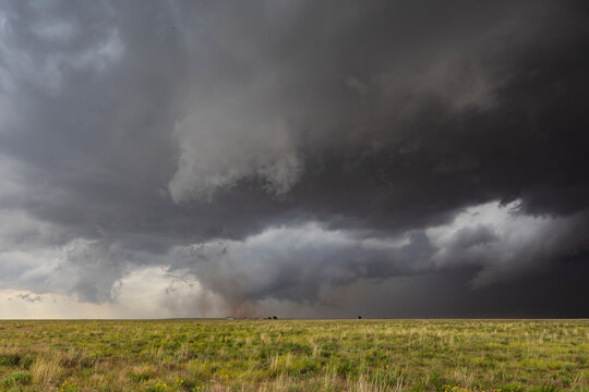 Tornado Touchdown, The Morton Supercell, a Tornado-Producing Supercell, tornados reaching down to the ground n the horizon.
