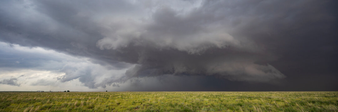 The Morton Supercell, Tornado-Producing Supercell, clouds gathering above the ground, dark shapes on the horizon.