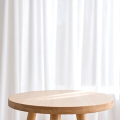 A rustic wooden table sits in the foreground, complemented by soft, flowing white curtains that gently frame a sunlit window in the background.