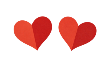 Two vibrant red heart shapes, designed to look like folded paper, set against a black backdrop