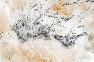 Water surface abstract, long exposure of river water flowing over boulders and rocks