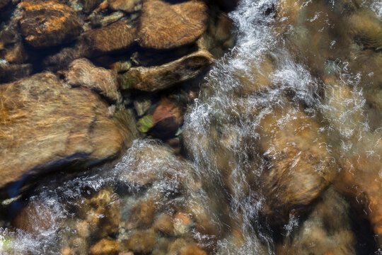 River water, long exposure of river water flowing over boulders and rocks