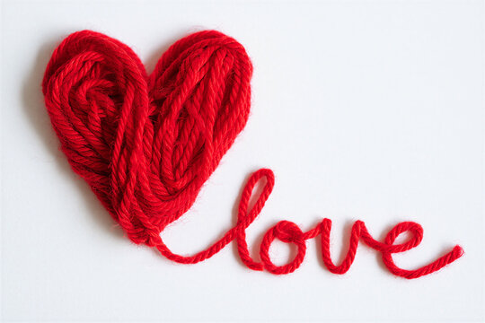 Red yarn heart shape with love word on white background for valentines day or romantic concepts