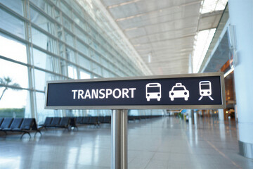 Transport sign with bus car and train icons in airport terminal with chairs and large windows  travel information board
