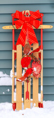 Decorative Red Sled With a Bow and Ornaments on a Winter Day