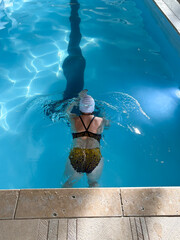 Swimmer Practices Strokes in Clear Water Under Bright Sunlight