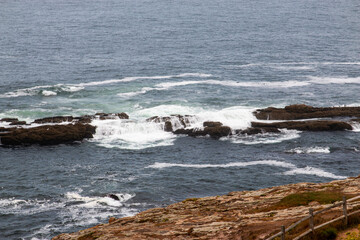 Waves Crashing on Rocks Near Tower of Hercules in A Coruna, Spain